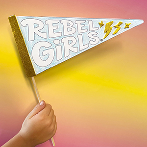 Thumbnail illustration of a child's hand holding a large Rebel Girls pennant